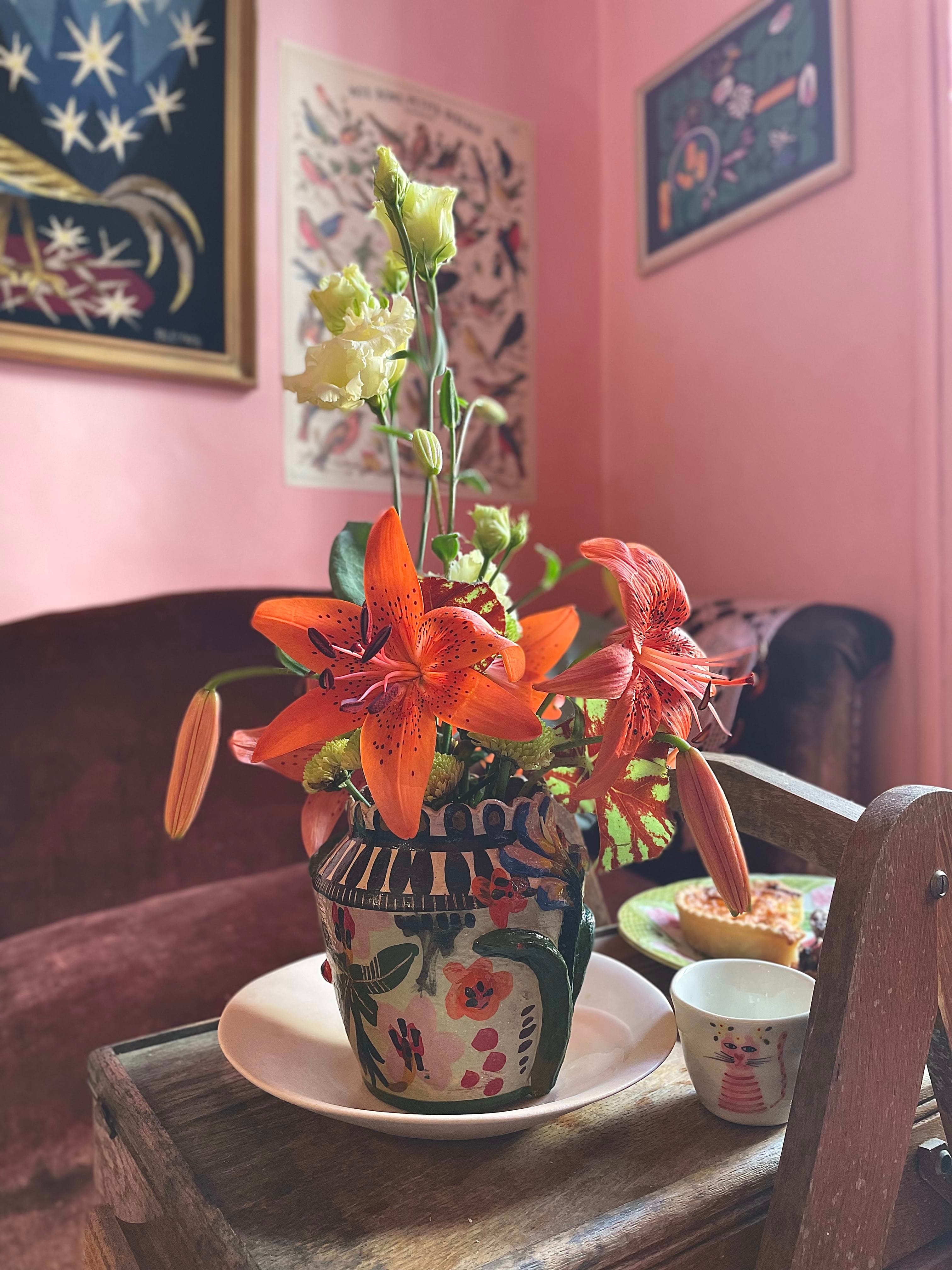 Vase of lilies in illustrated botanical composition, everyday ritual aesthetic