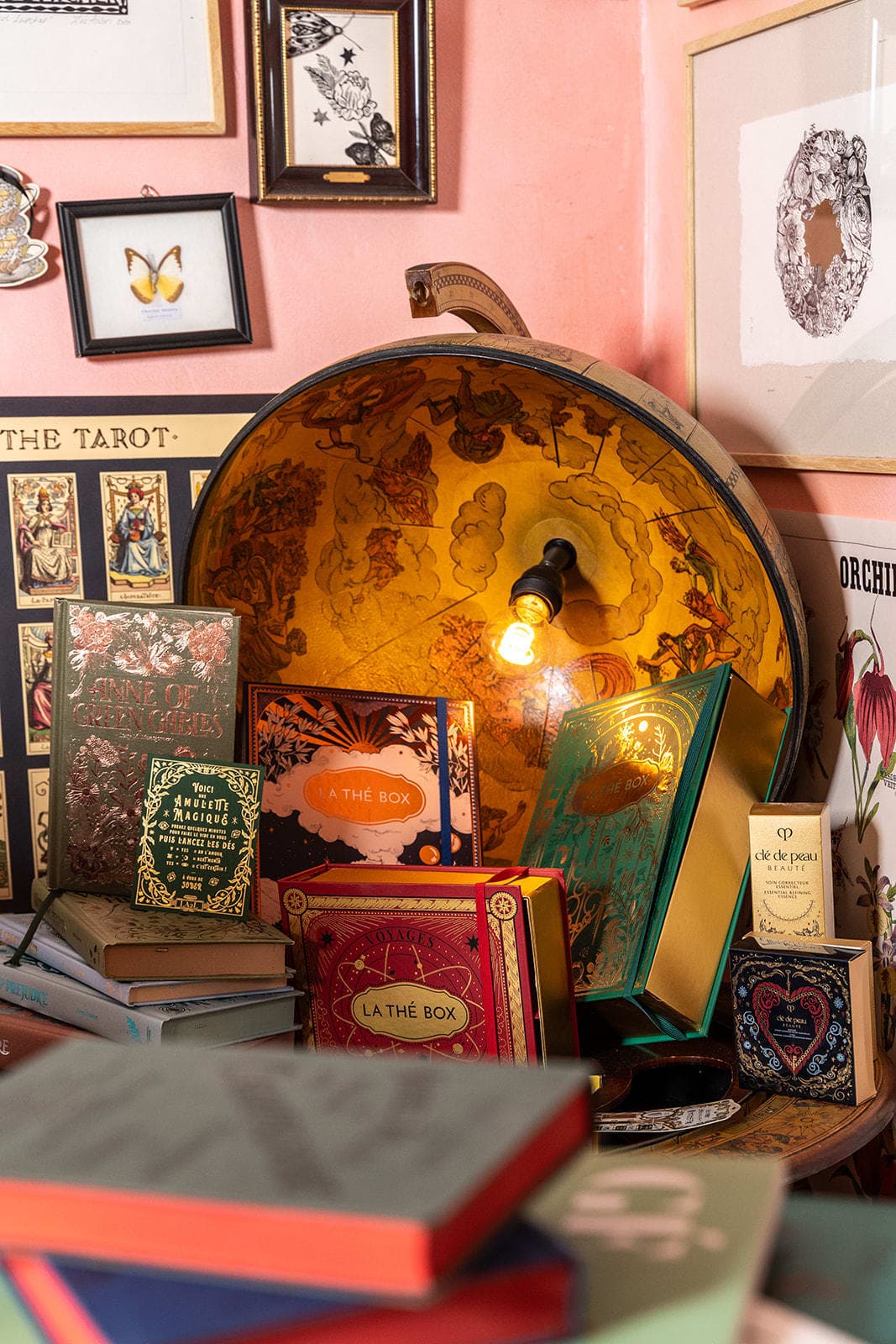 Studio desk with stacked botanical reference books and vintage task lamp