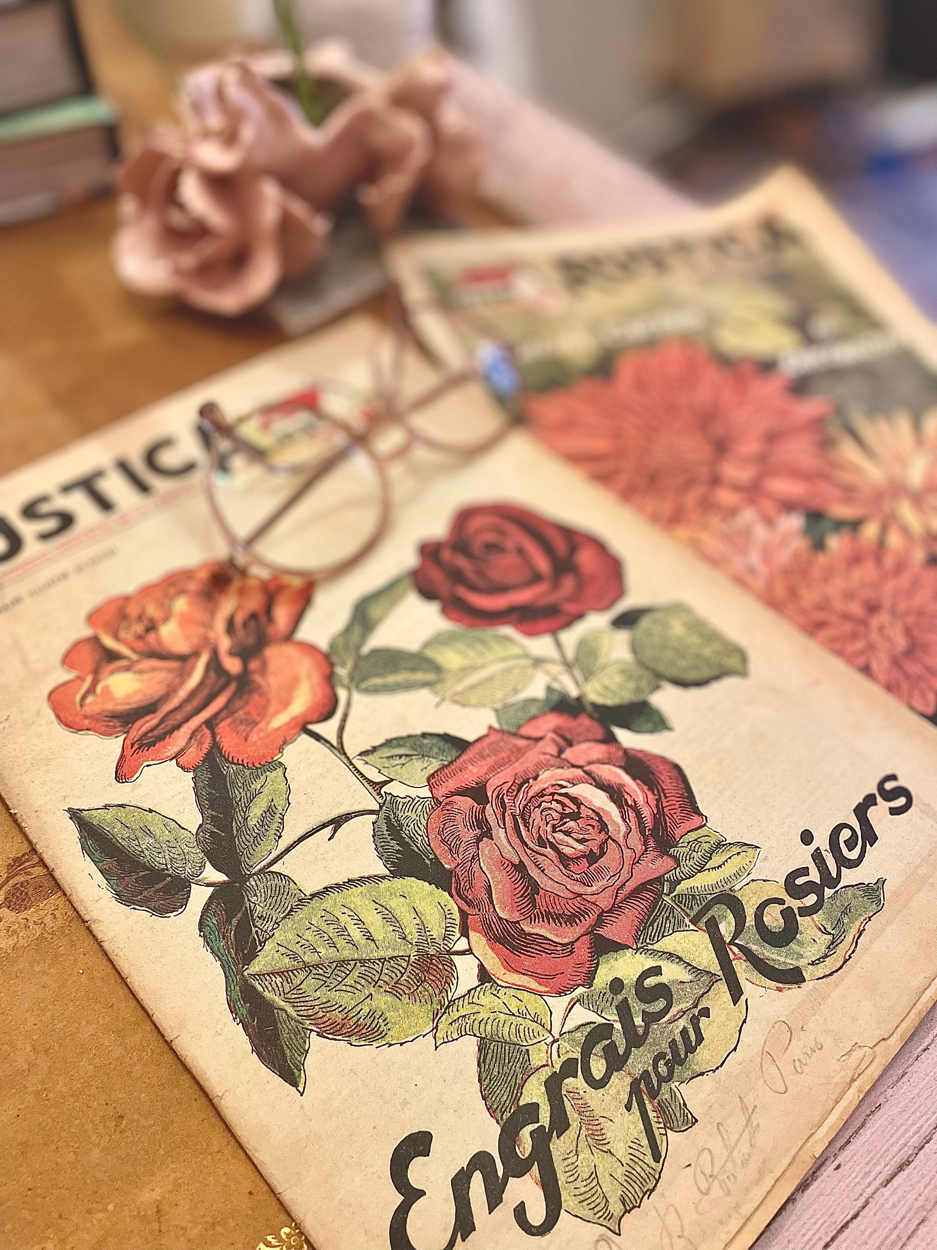 Desk detail with glasses resting on a botanical tome, studious atmosphere
