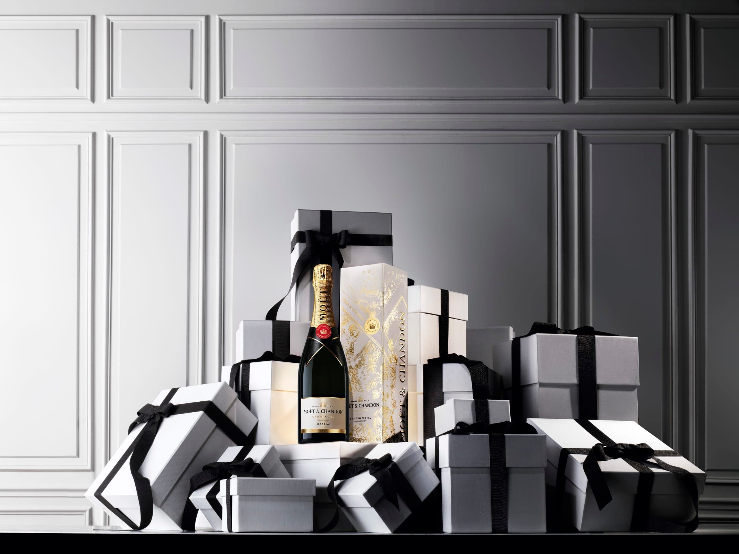 Moët & Chandon bottle resting on a stack of gift boxes
