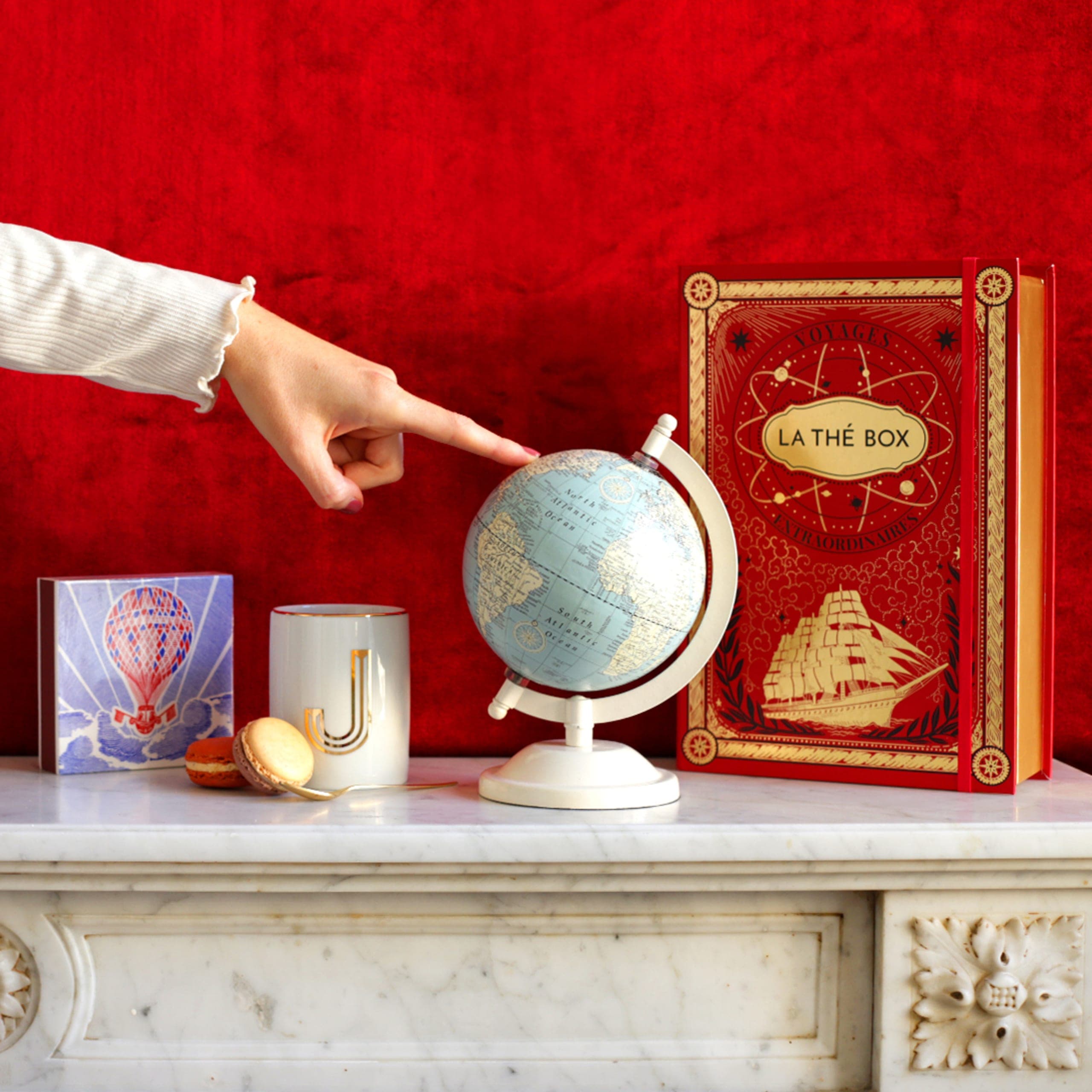 illustrated thébox in a scene with figure pointing at a globe