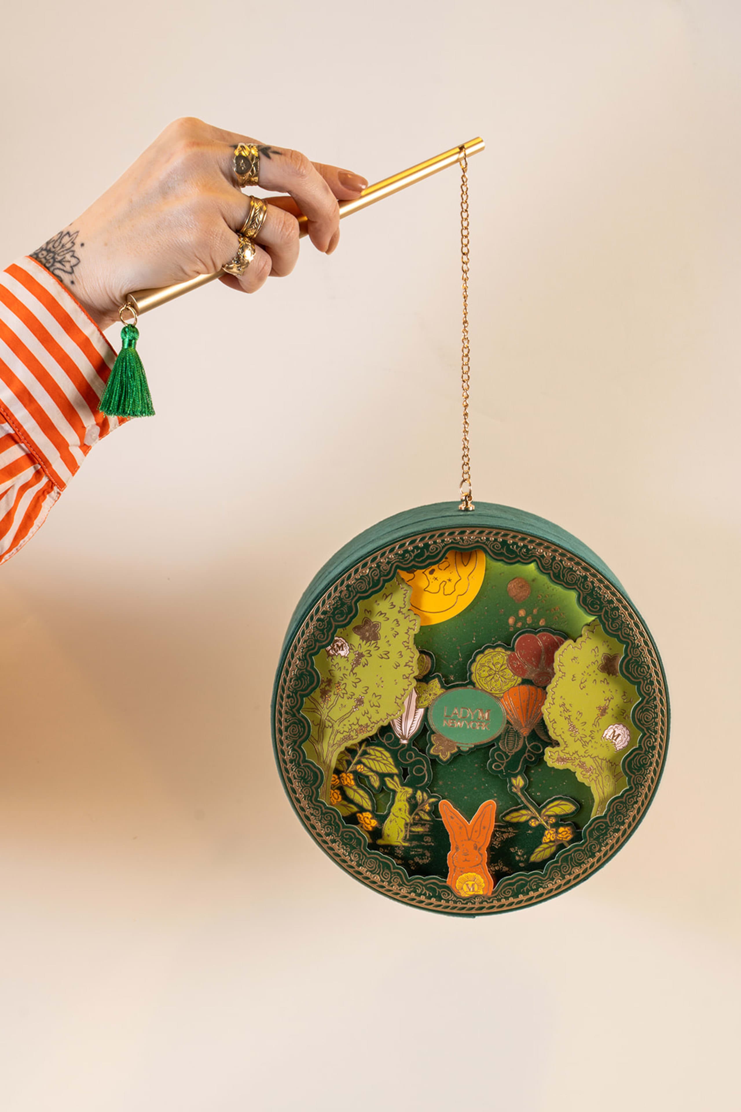 hand holding a 2024 Lady M Mid-Autumn illustrated lantern box