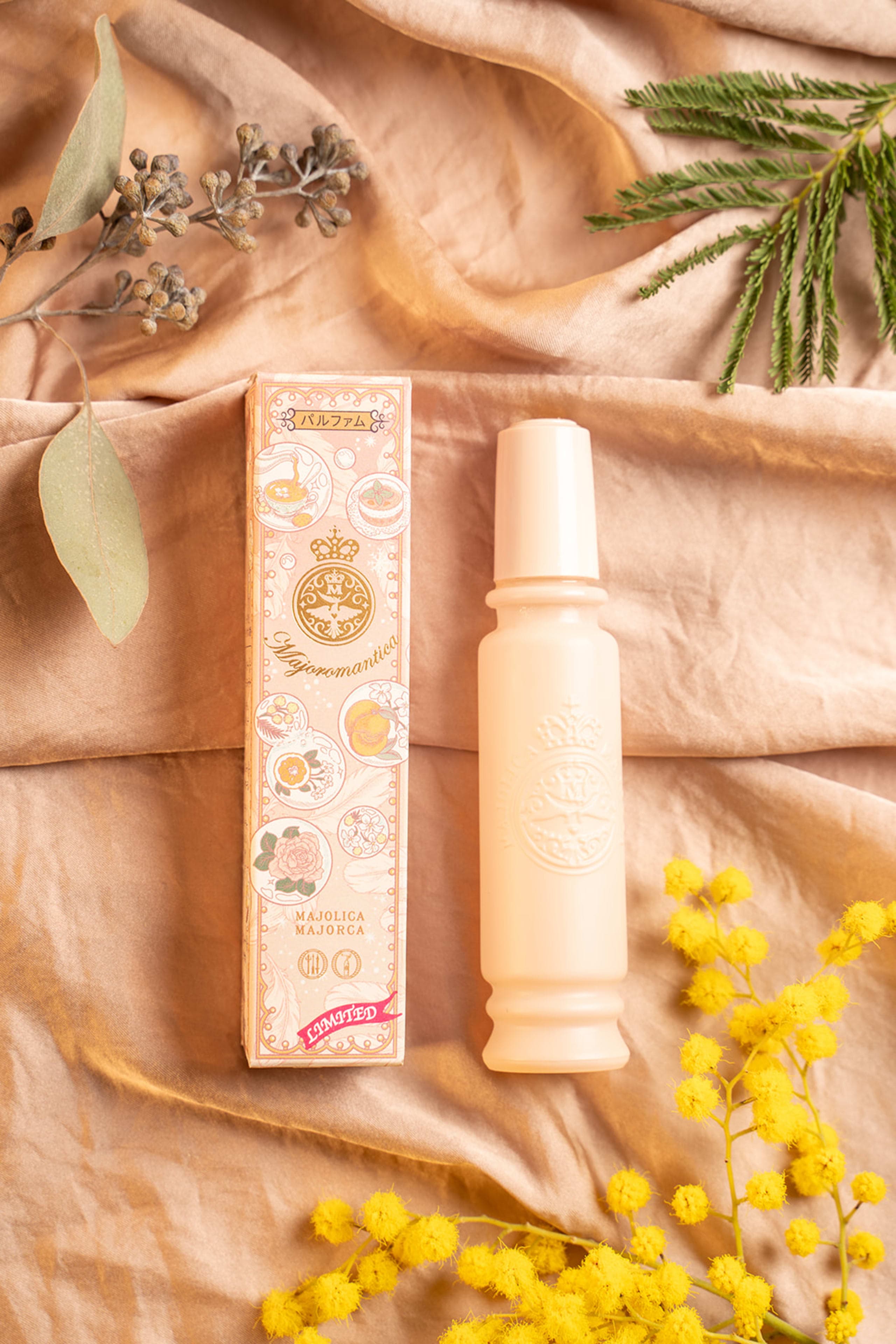 Majolica Majorca illustrated packaging, perfume bottle beside a mimosa