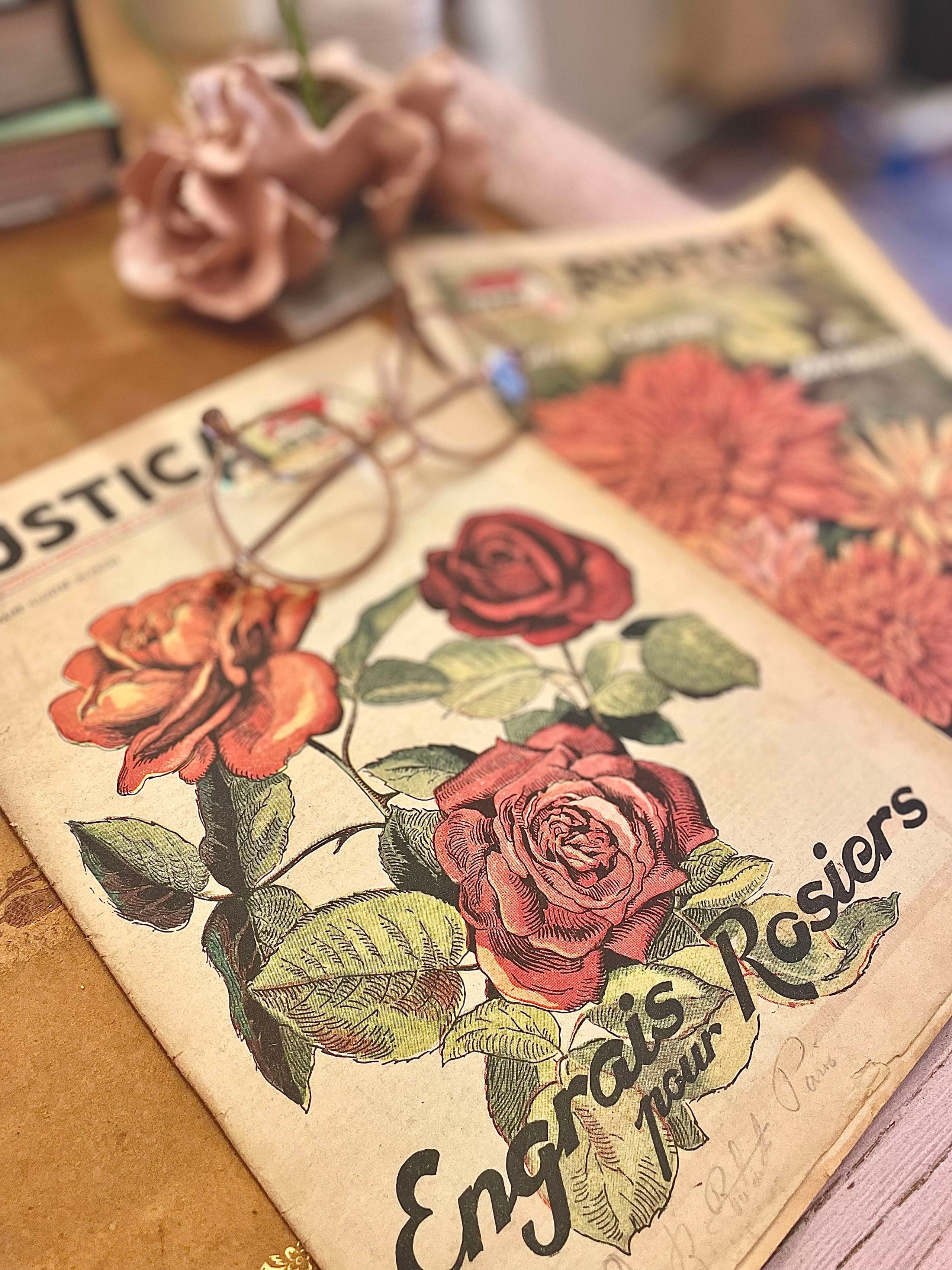 Desk detail with glasses resting on a botanical tome, studious atmosphere